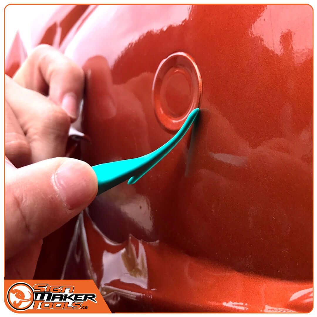Using the WrapStick Eco Flex to apply film around a parking sensor on a car bumper